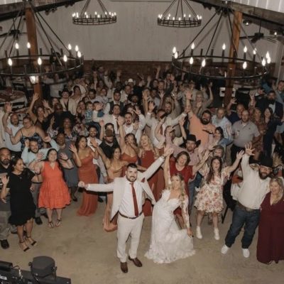 Joyful indoor wedding reception full dance floor celebration at Milagro Venue Texas